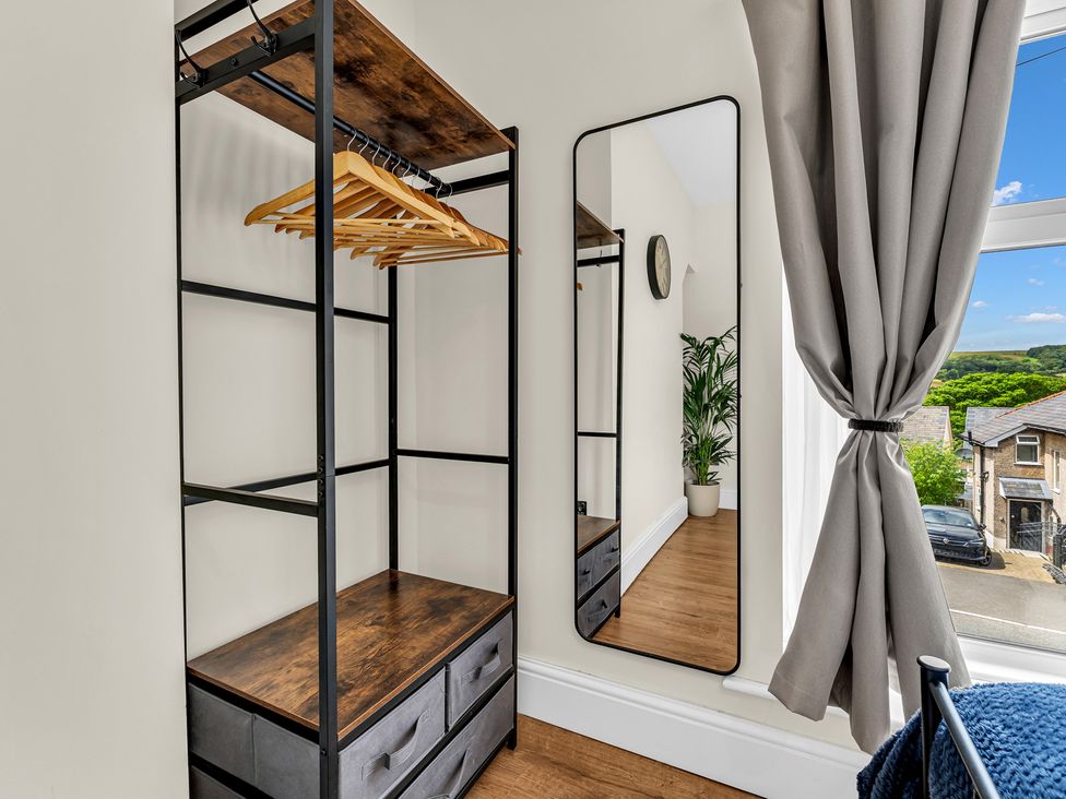 A dressing room with a clothes rack and mirror at Peak View Terrace