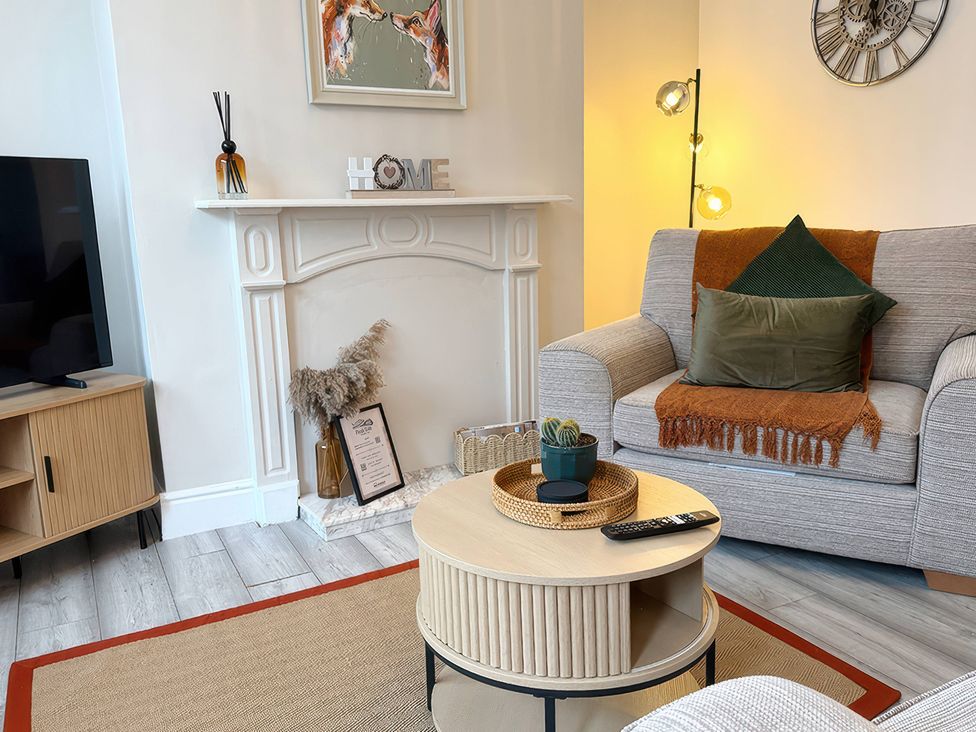 A living room with a sofa and coffee table at Peak Side Terrace in Buxton