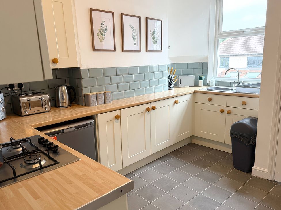 A kitchen with a sink and appliances at Peak Side Terrace in Buxton