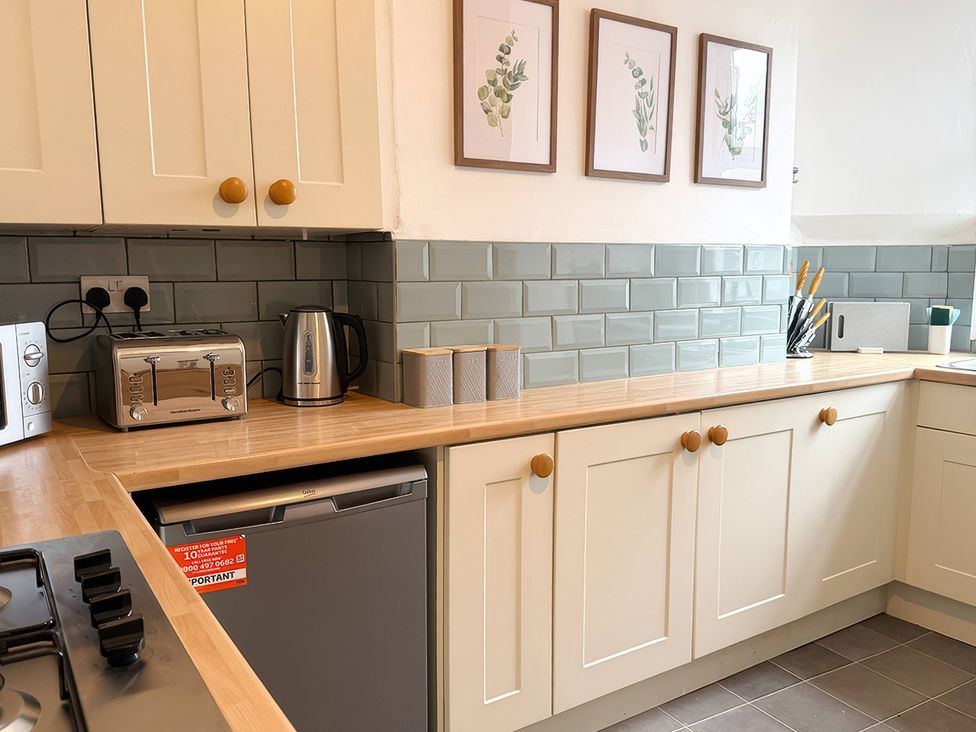 A kitchen with a fridge, toaster, and kettle at Peak Side Terrace in Buxton