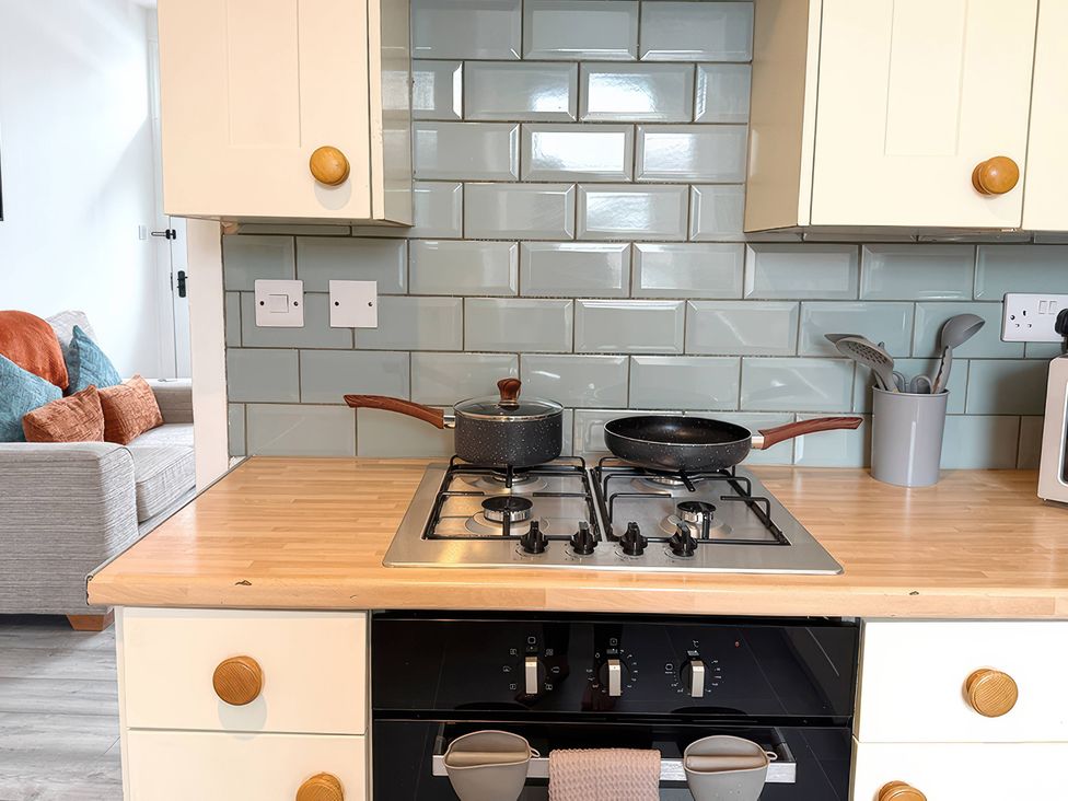 A kitchen with a cooking hob and utensils at Peak Side Terrace in Buxton