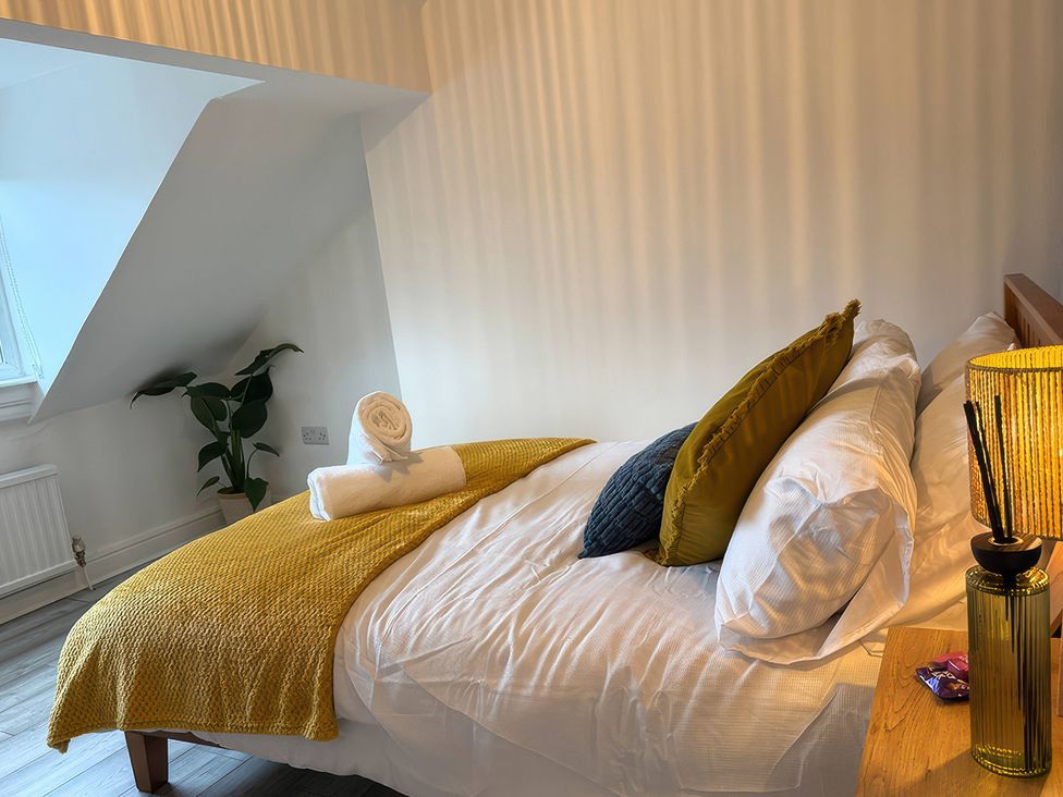 A bedroom with a bed and pillows at Peak Side Terrace in Buxton