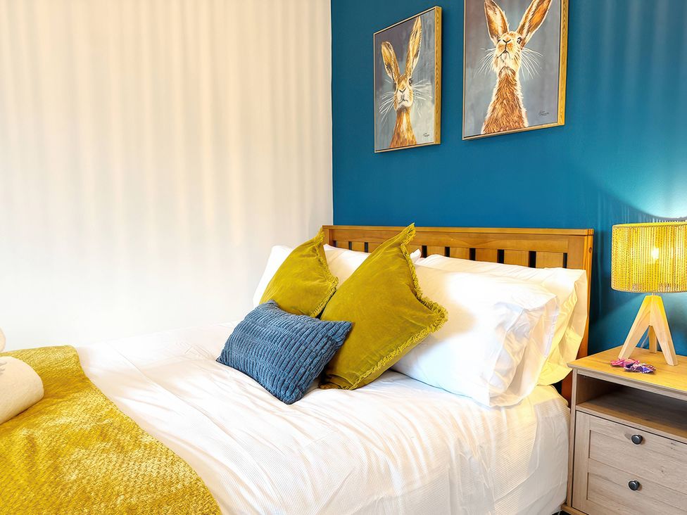 A bedroom with a bed and wall art at Peak Side Terrace in Buxton