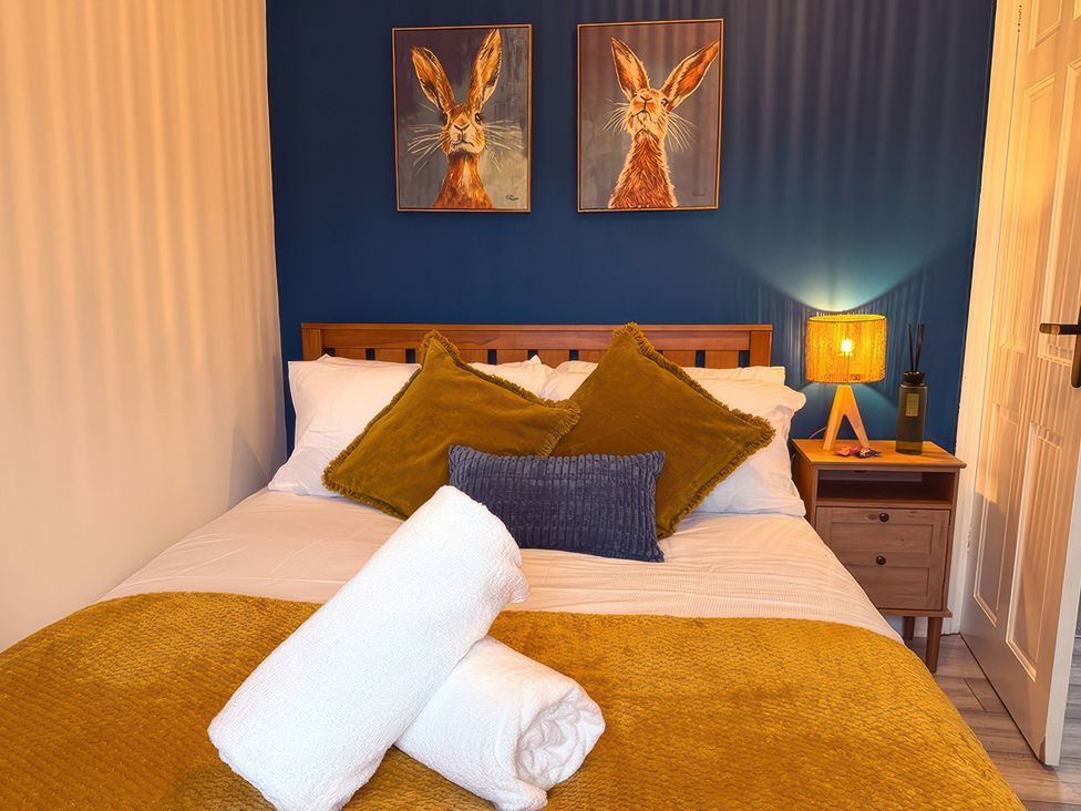 A bedroom with a bed and pillows at Peak Side Terrace in Buxton