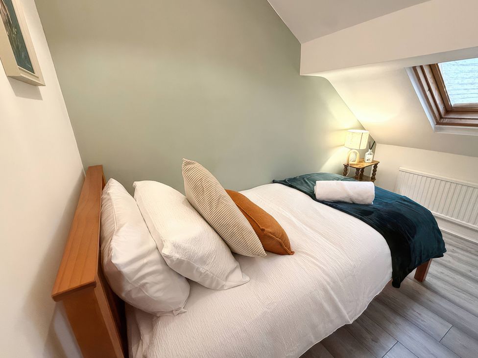 A bedroom with a bed and lamp at Peak Side Terrace Buxton