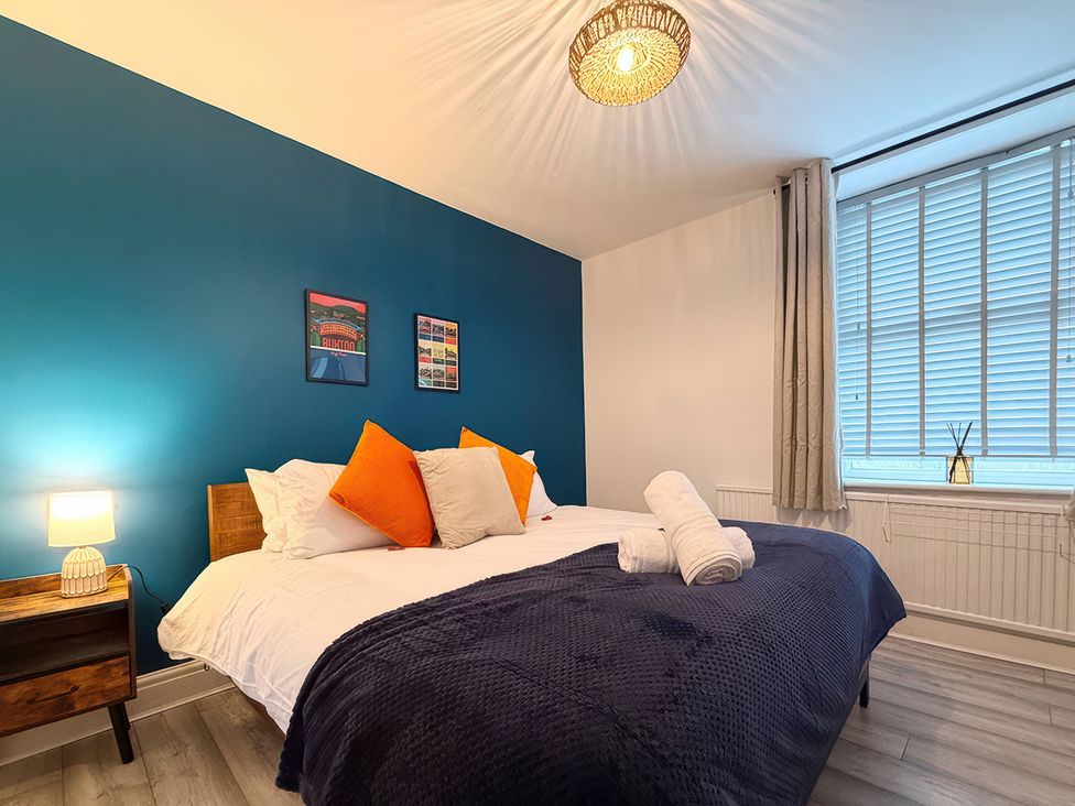 A bedroom with a bed and bedside table at Peak Side Terrace in Buxton