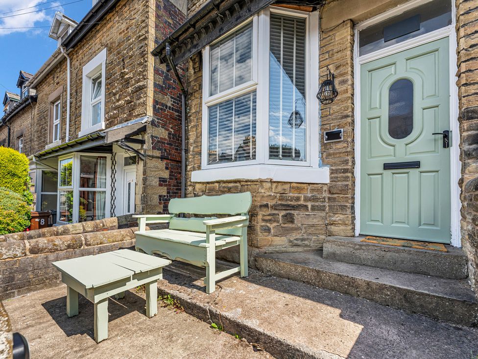 A front entrance with a bench and table at Peak Side Terrace in Buxton