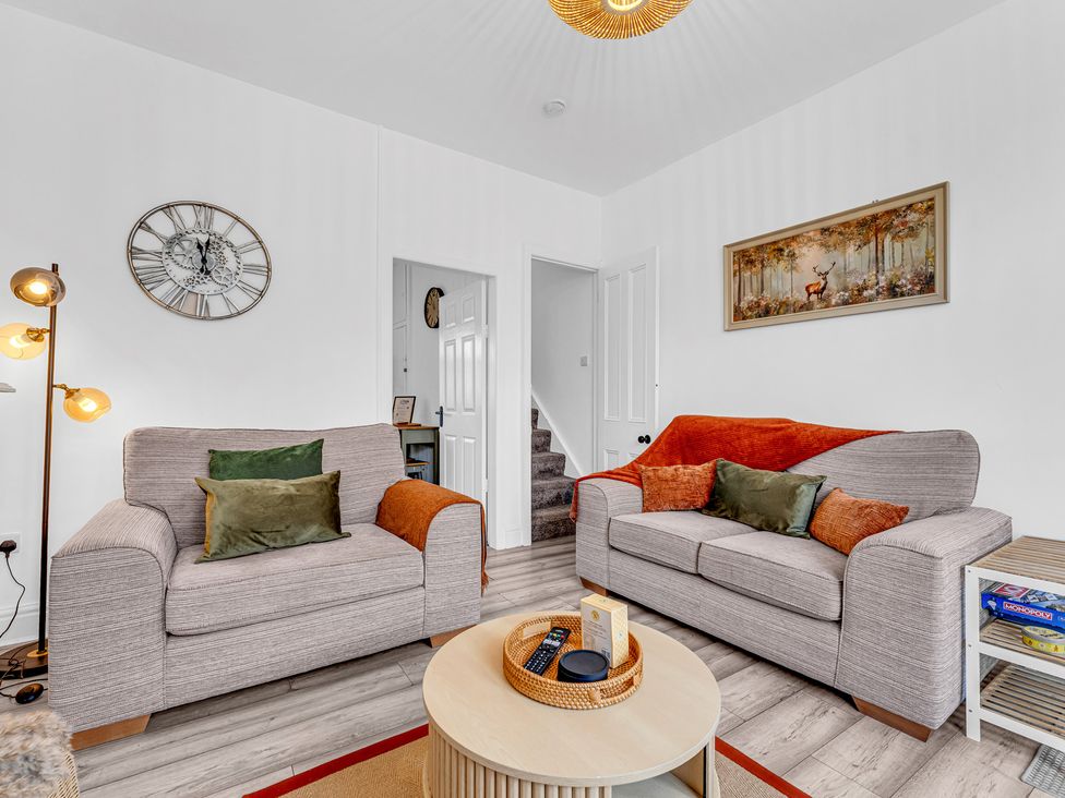 A living room with a sofa and armchair at Peak Side Terrace in Buxton