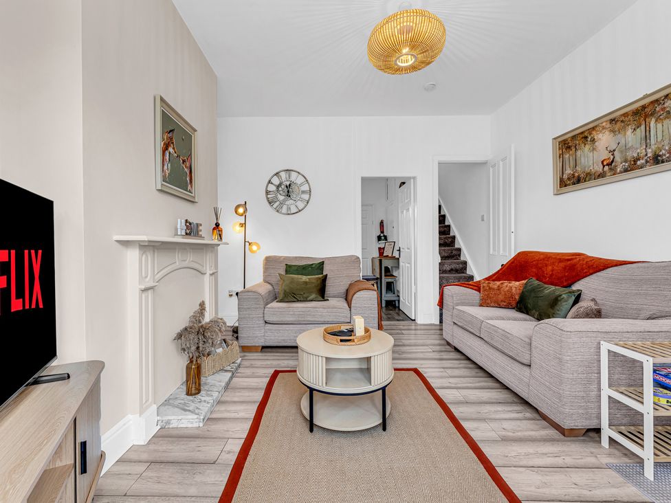 A living room with a coffee table and sofas at Peak Side Terrace in Buxton