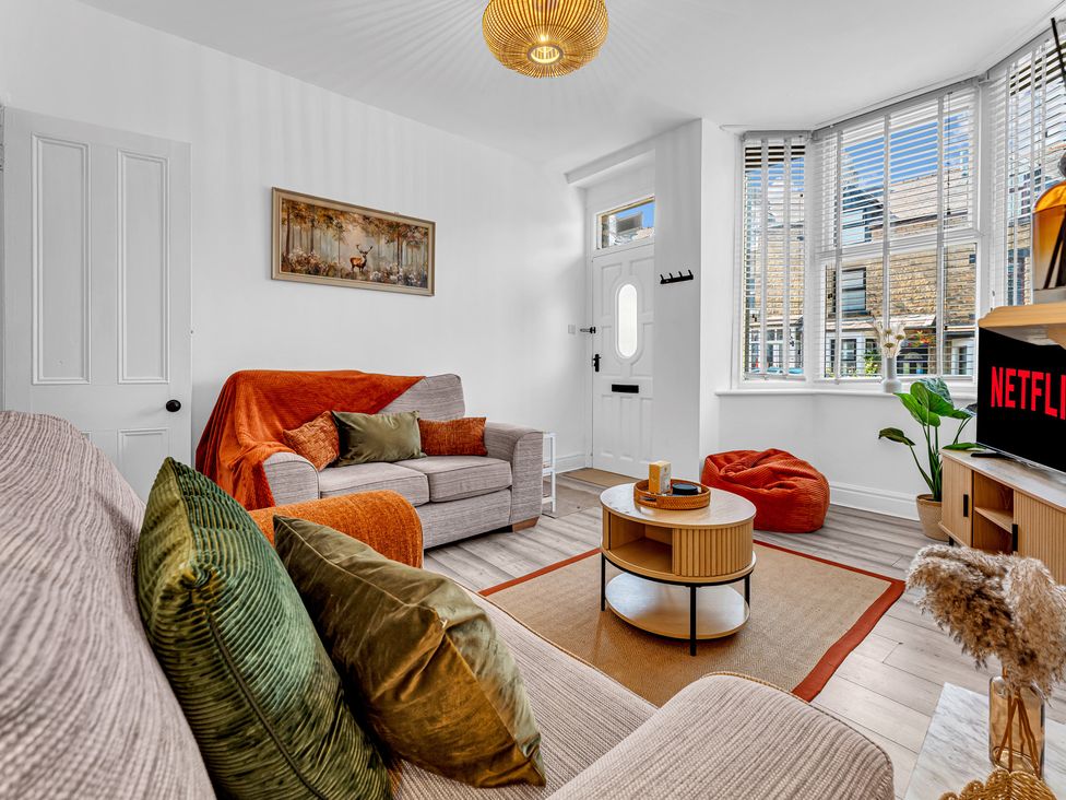 A living room with a sofa and coffee table at Peak Side Terrace in Buxton