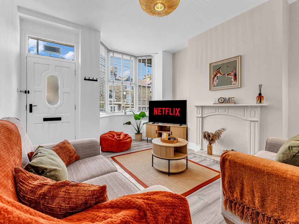 A living room with a television and coffee table at Peak Side Terrace in Buxton