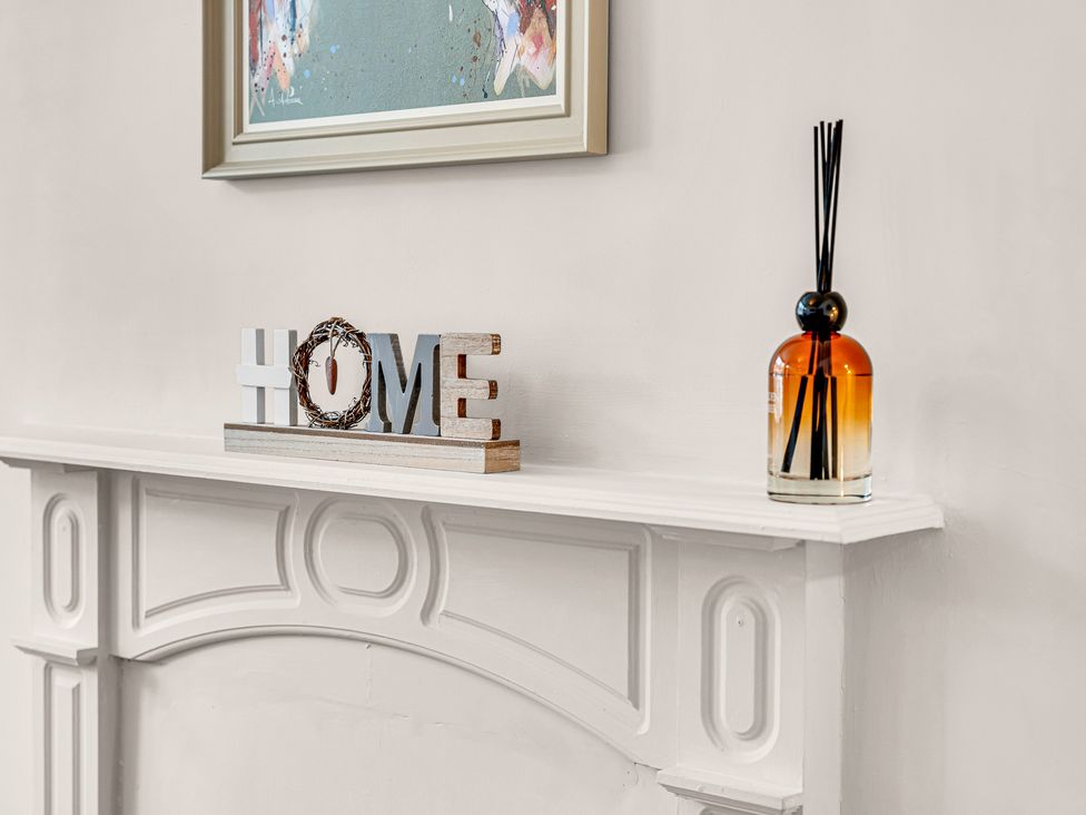 A shelf with letters spelling HOME and a reed diffuser at Peak Side Terrace in Buxton