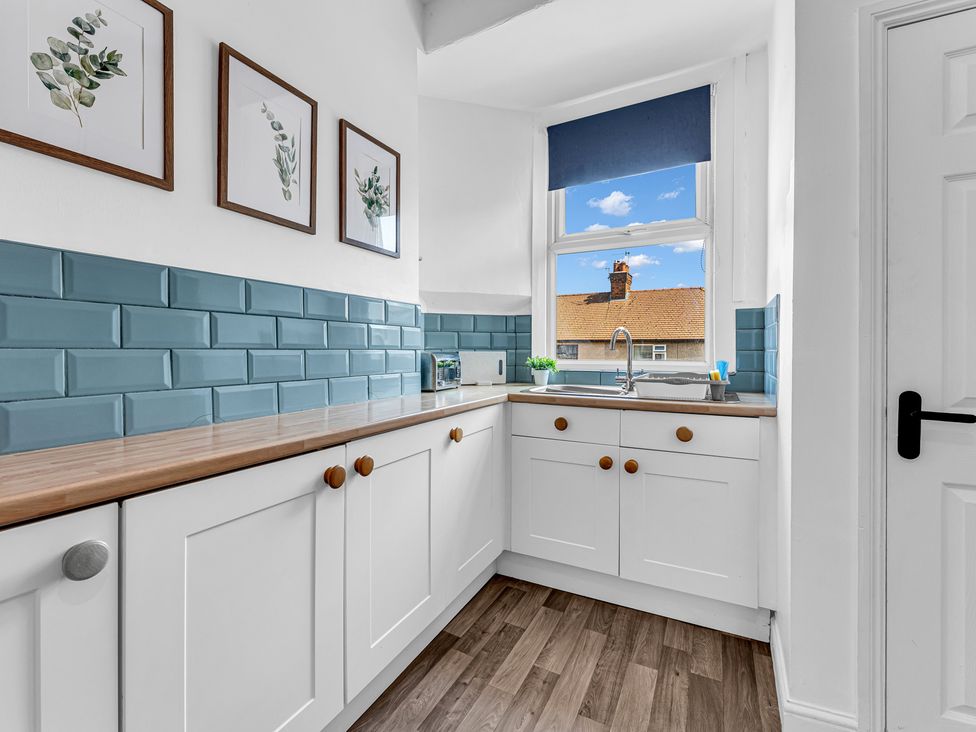 A kitchen with cabinets and a sink at Peak Side Terrace in Buxton