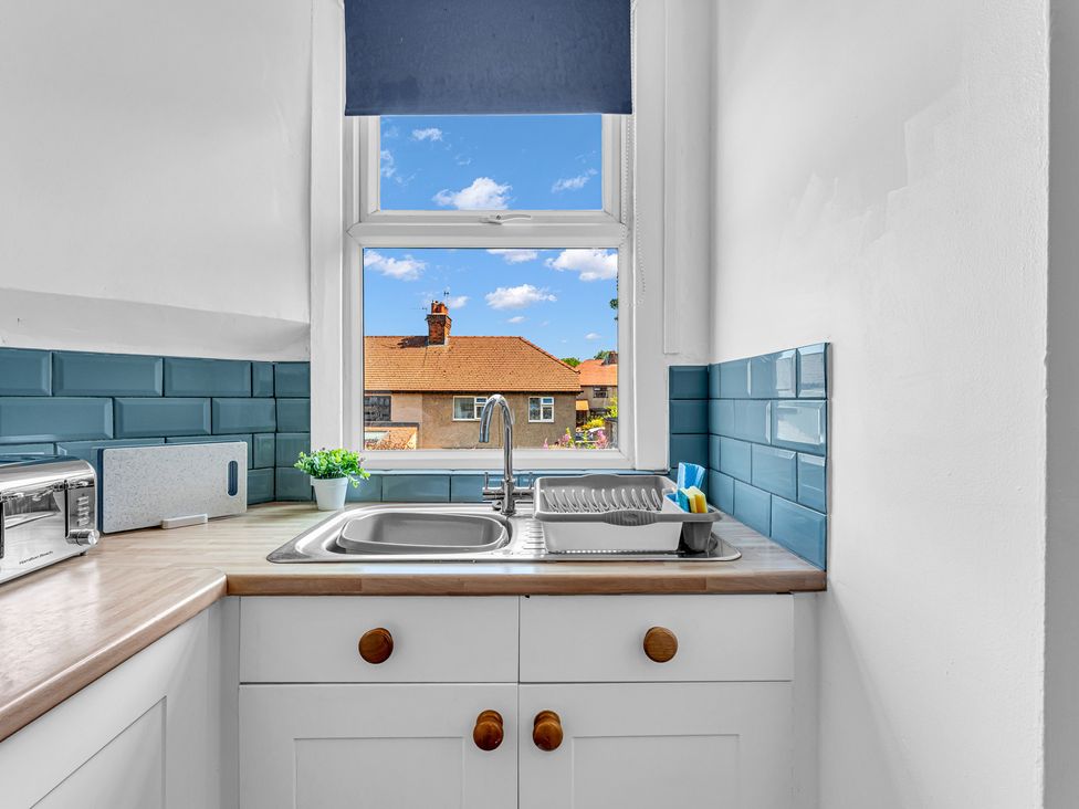 A kitchen with a sink and window at Peak Side Terrace in Buxton