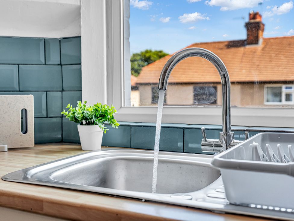 A kitchen sink with a faucet and dish drainer at Peak Side Terrace in Buxton