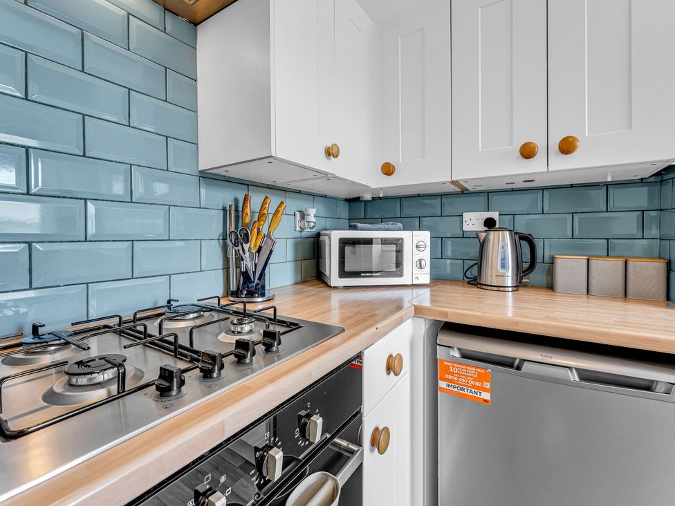 A kitchen with appliances and utensils at Peak Side Terrace in Buxton