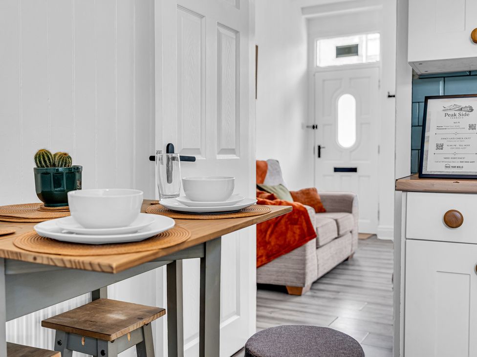 A dining area with table and chairs at Peak Side Terrace in Buxton