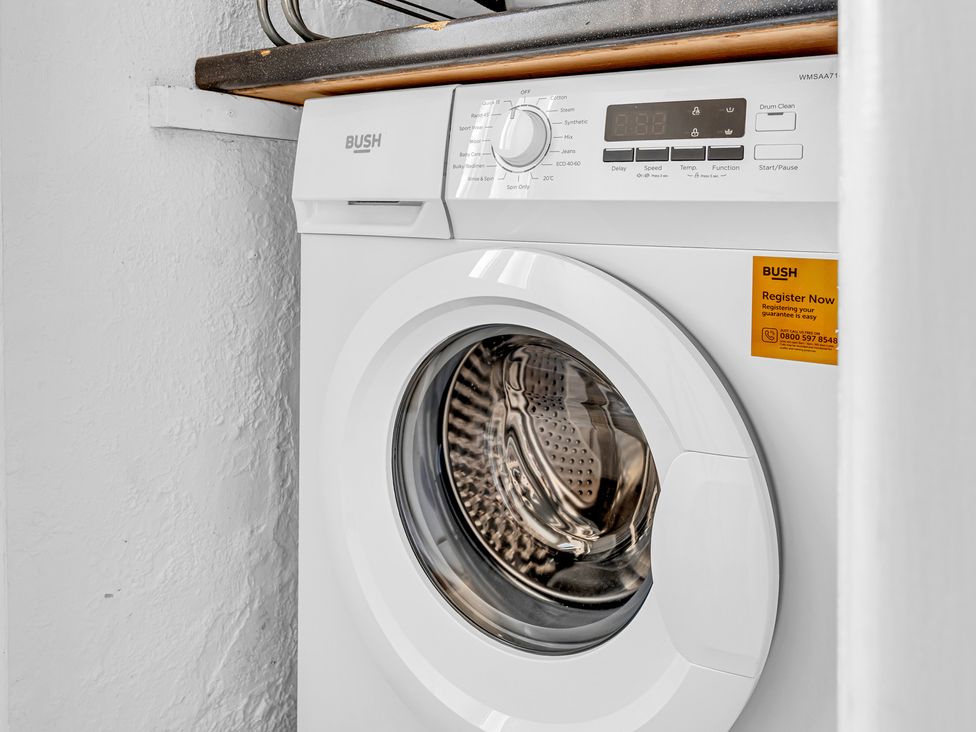 A washing machine with control panel and detergent compartment at Peak Side Terrace in Buxton