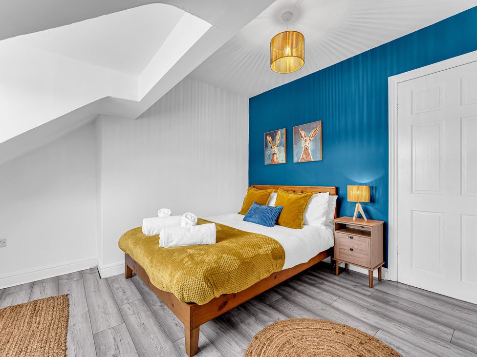 A bedroom with a bed and bedside table at Peak Side Terrace in Buxton