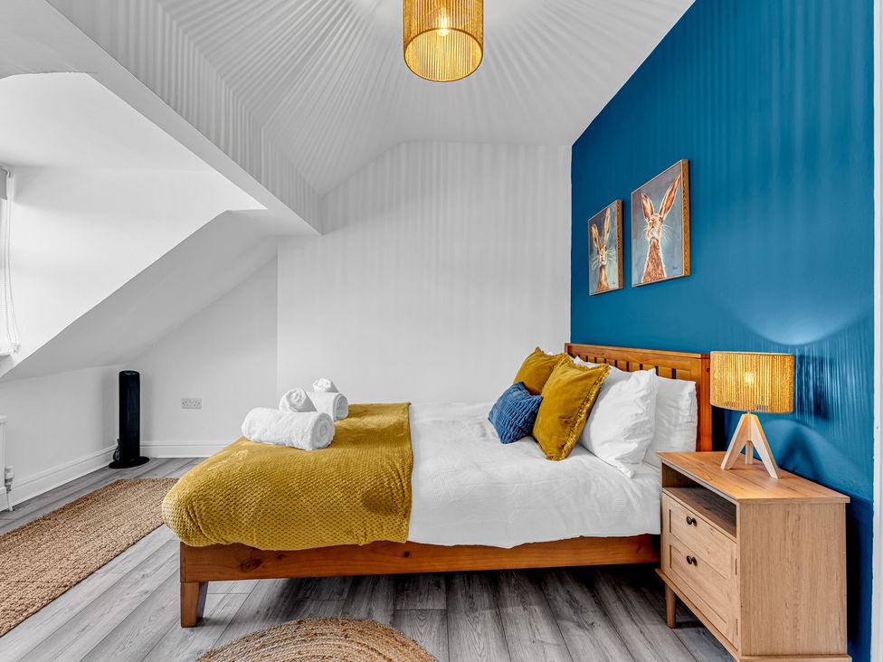 A bedroom with a bed and bedside table at Peak Side Terrace in Buxton