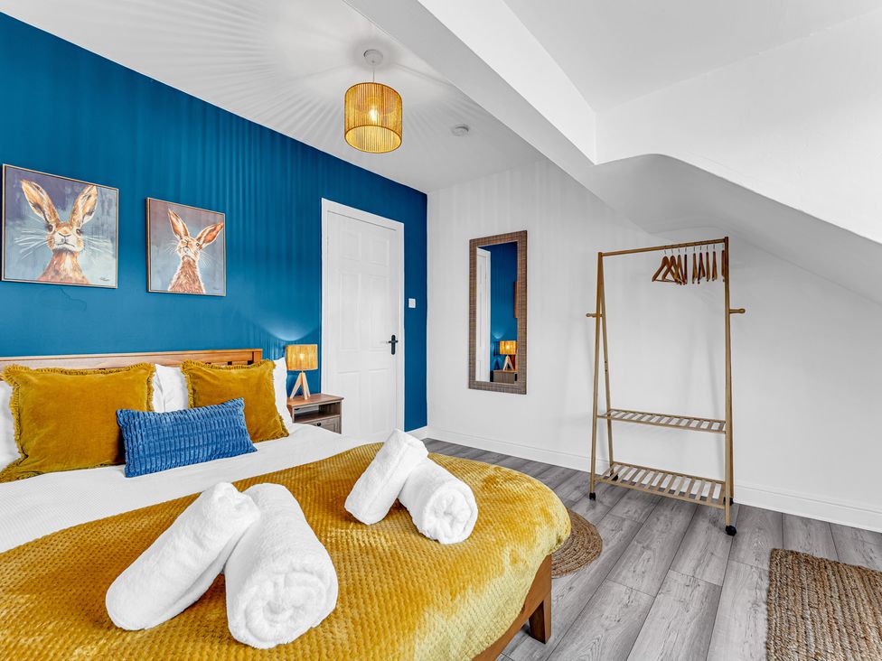 A bedroom with a bed and clothes rack at Peak Side Terrace in Buxton