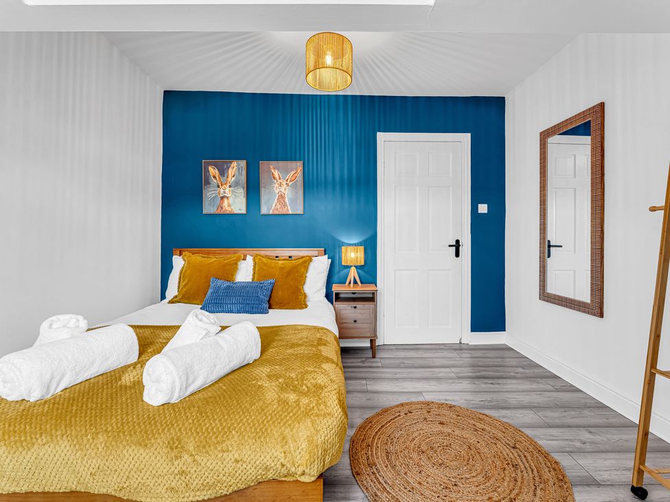 A bedroom with a bed and nightstand at Peak Side Terrace in Buxton