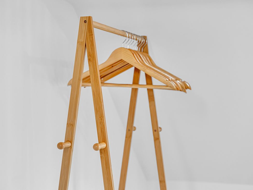 A clothes rack with wooden hangers at Peak Side Terrace Buxton