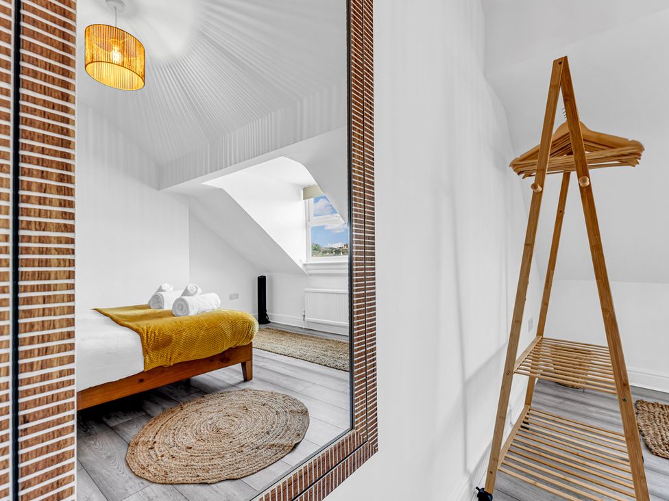 A bedroom with a bed and towels on display at Peak Side Terrace in Buxton