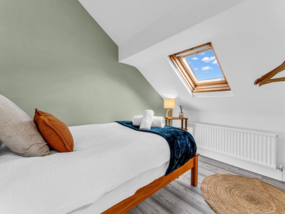 A bedroom with a bed and skylight at Peak Side Terrace in Buxton