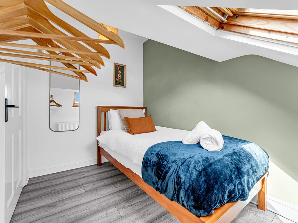 A bedroom with a bed and hanging items at Peak Side Terrace in Buxton