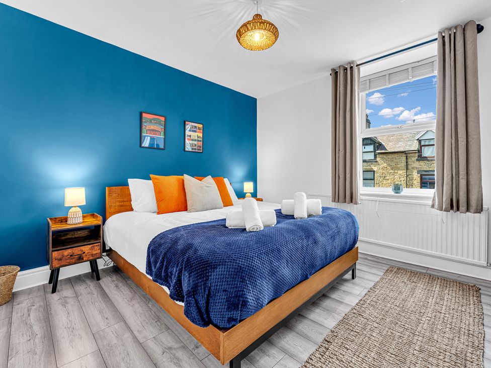 A bedroom with a bed and nightstand at Peak Side Terrace in Buxton
