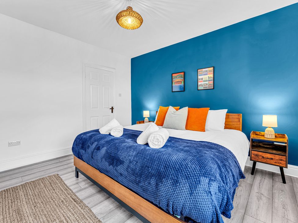 A bedroom with a bed and nightstands at Peak Side Terrace in Buxton