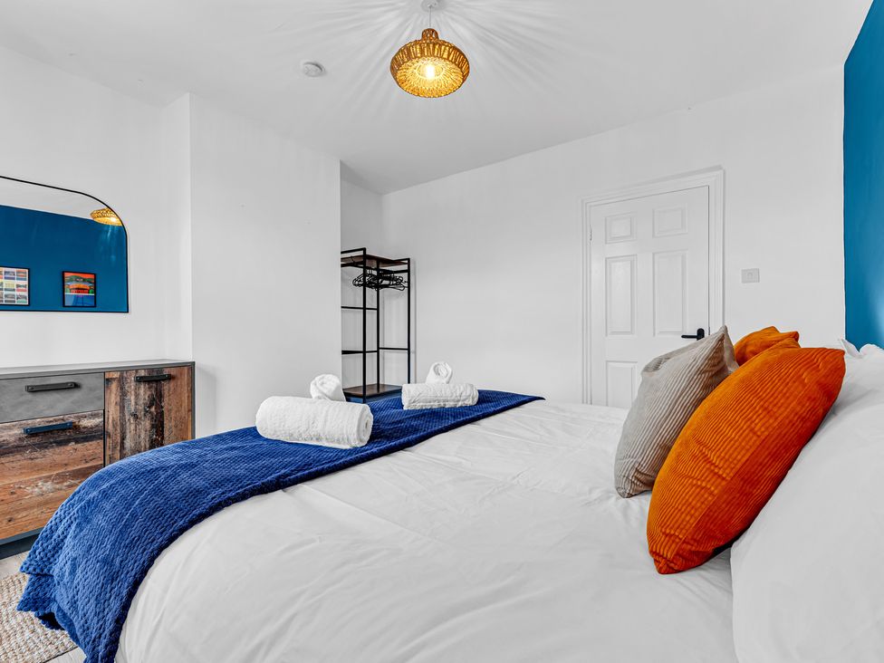 A bedroom with a bed and wardrobe at Peak Side Terrace in Buxton