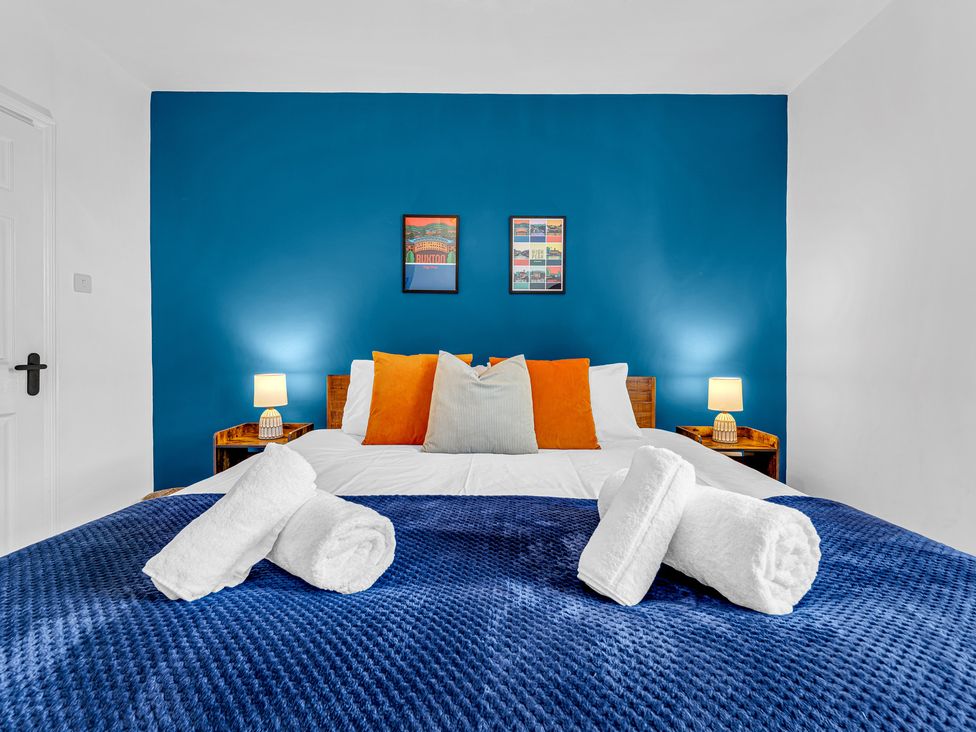 A bedroom with a bed and decorative items at Peak Side Terrace in Buxton