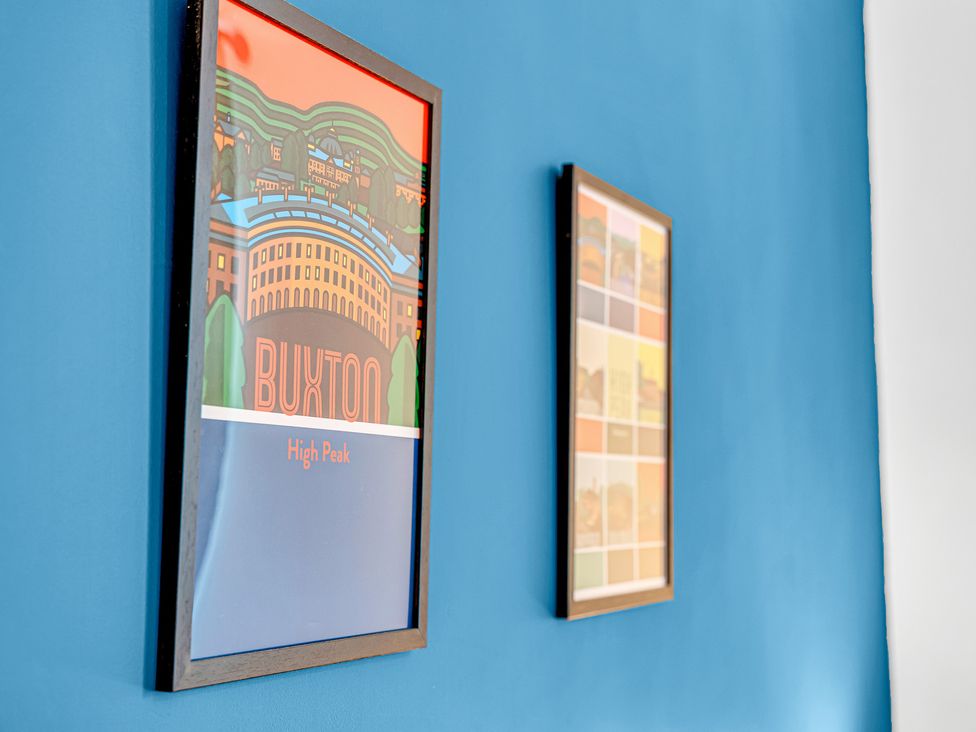 Framed artwork on a blue wall at Peak Side Terrace in Buxton
