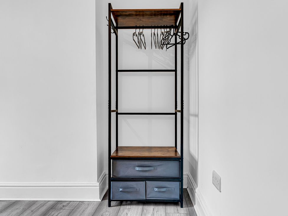 A shelf with coat hangers and drawers at Peak Side Terrace in Buxton