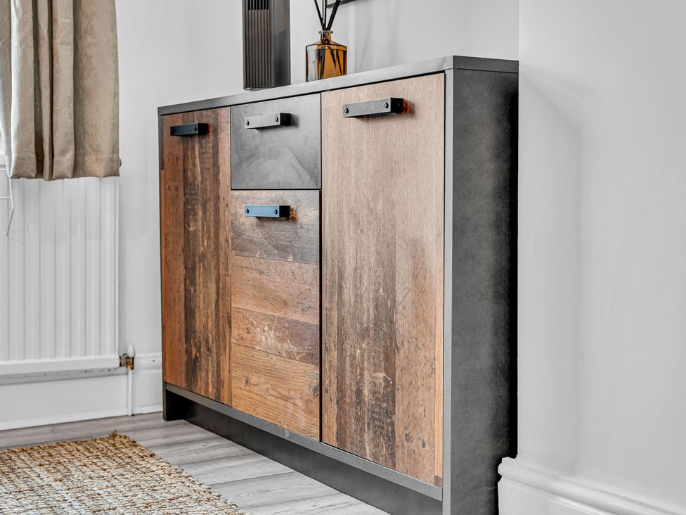 A cabinet with drawers and handles in a living room at Peak Side Terrace in Buxton