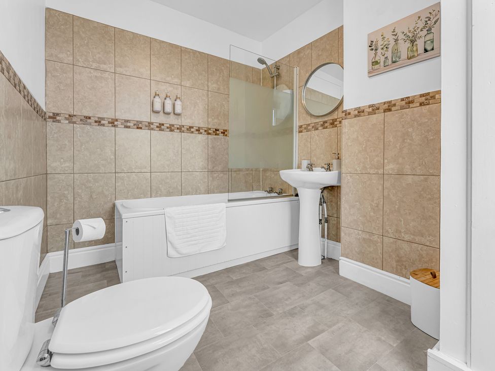 A bathroom with a bath tub and sink at Peak Side Terrace Buxton
