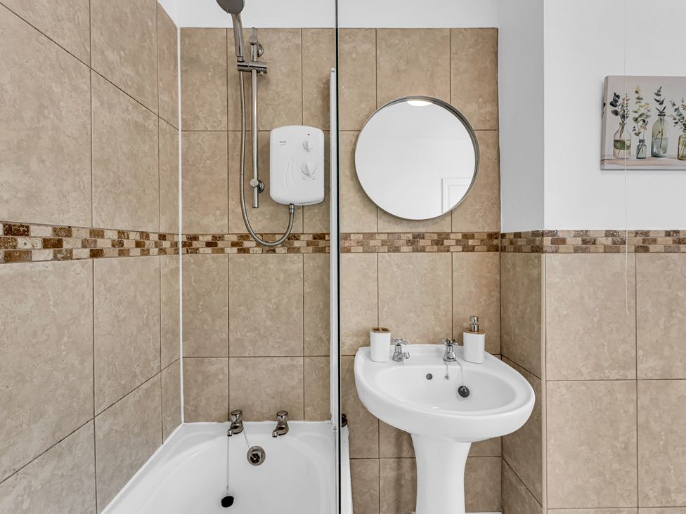 A bathroom with a shower and basin at Peak Side Terrace in Buxton
