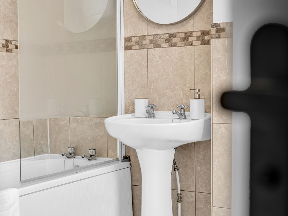 A bathroom with a sink and bathtub at Peak Side Terrace in Buxton