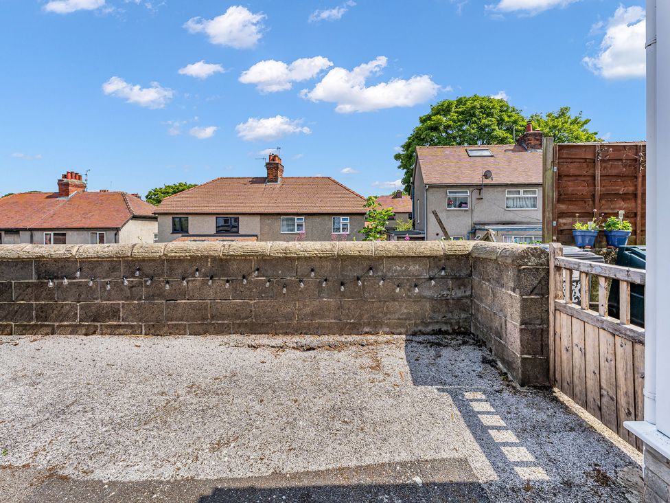 An outdoor area with houses in the background at Peak Side Terrace in Buxton