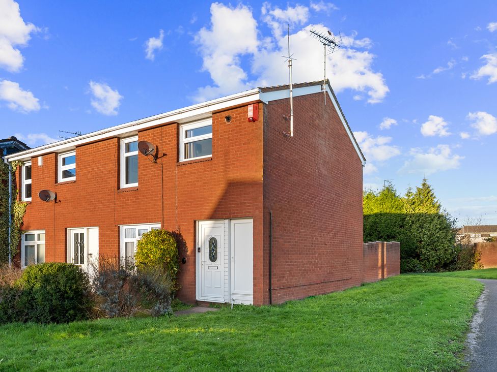 A house with a door and windows in front of a garden at Edison House Stafford