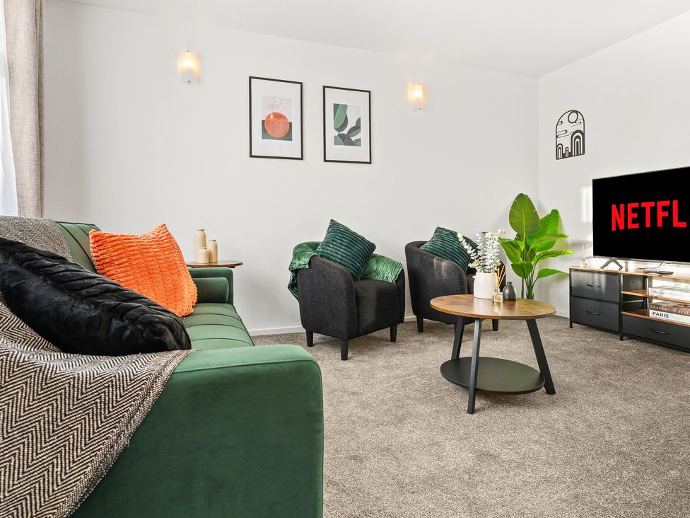 A living room with a sofa and armchairs at Edison House in Stafford