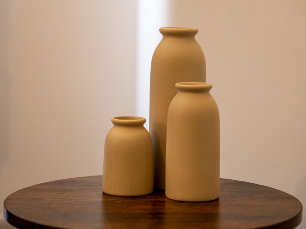 Three vases on a wooden table at Edison House Stafford