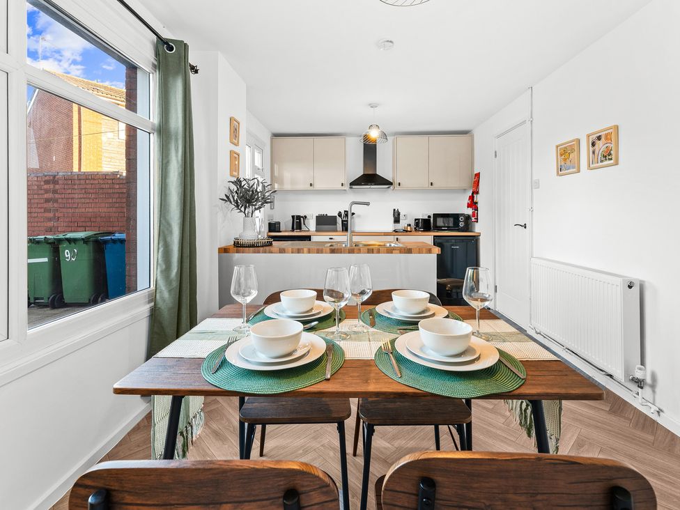 A dining area with a table set for four at Edison House in Stafford