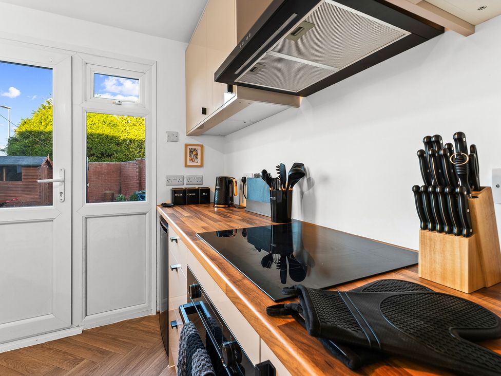 A kitchen with a cooktop and utensils at Edison House Stafford