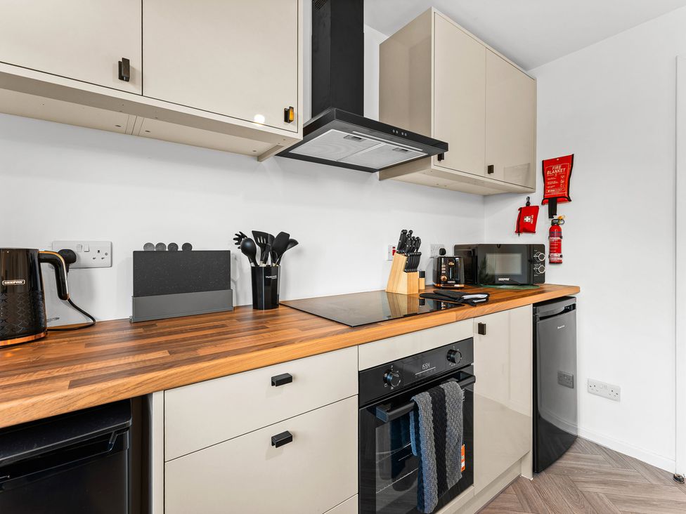 A kitchen with appliances and utensils at Edison House Stafford
