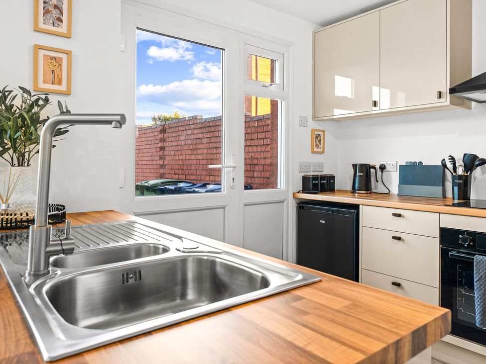 A kitchen with a sink and countertop at Edison House Stafford