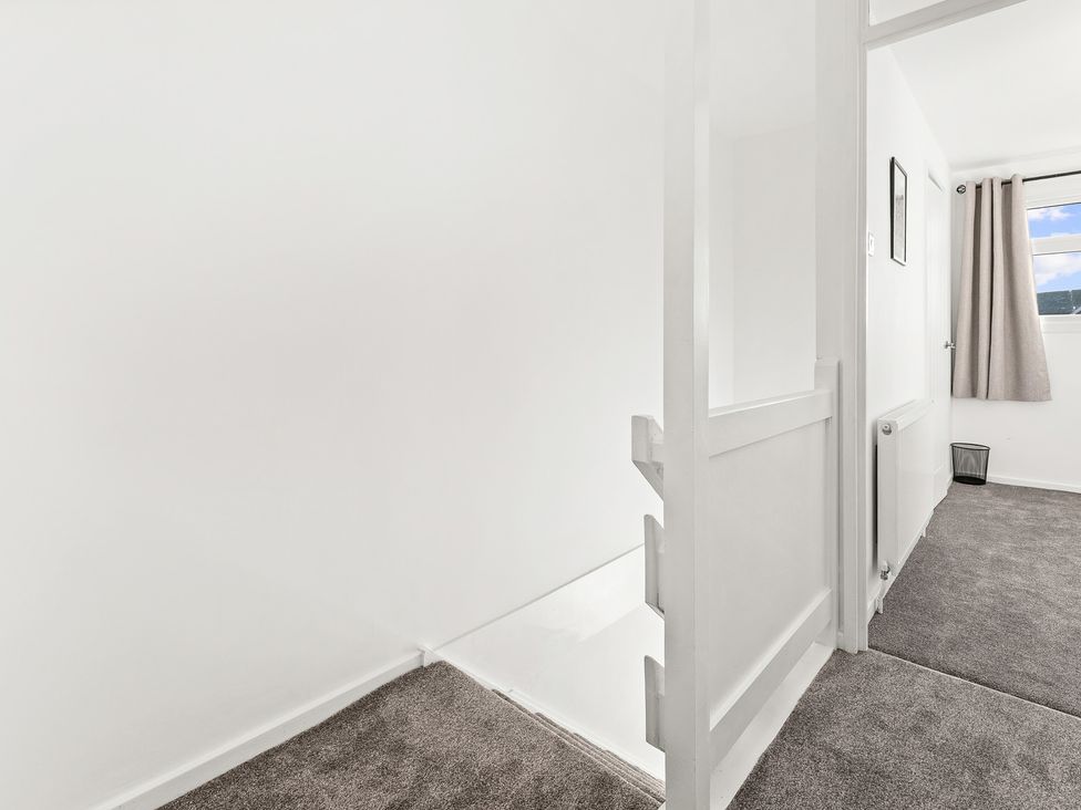 A hallway with a door and a window at Edison House Stafford
