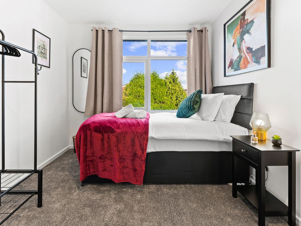 A bedroom with a bed and window at Edison House Stafford